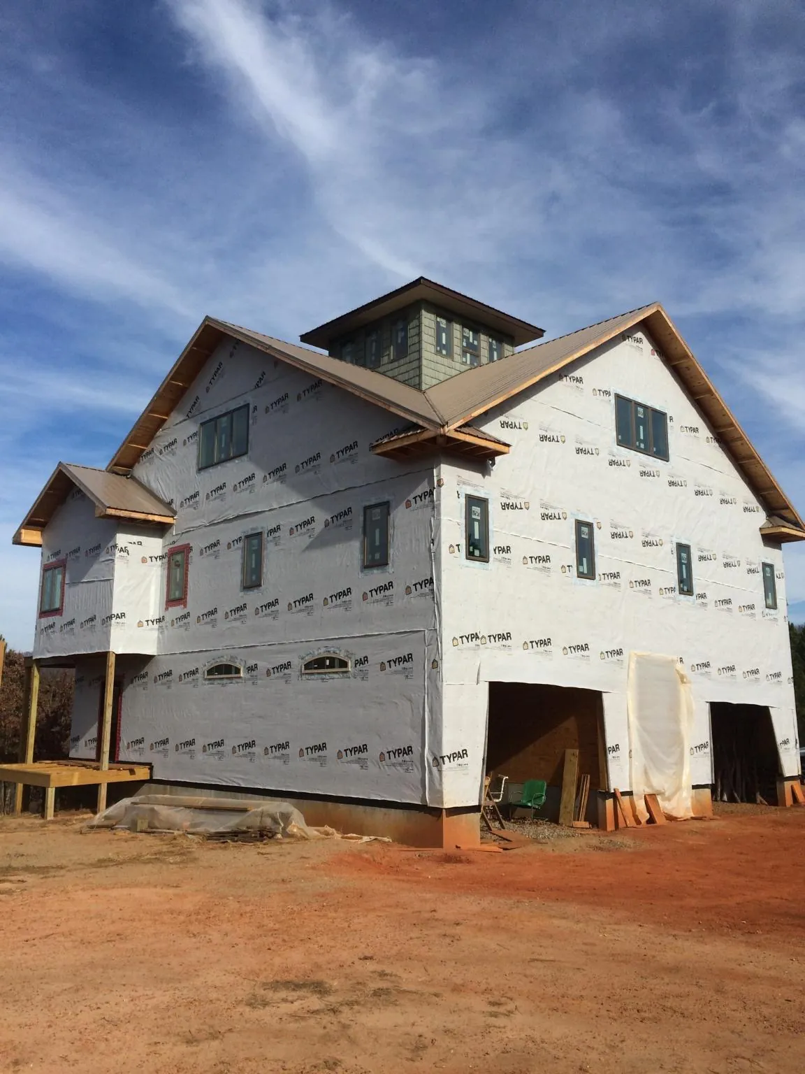 New two story house under construction with a cupola and gabled roofs in Radcliffe